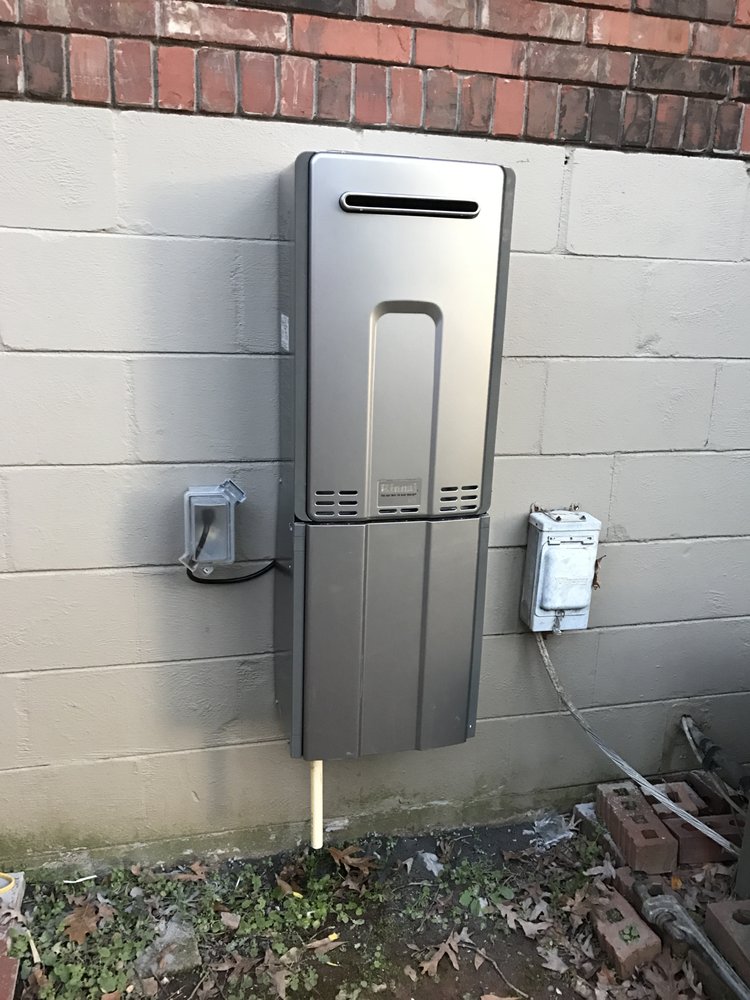 Tankless water heater installed on an exterior wall