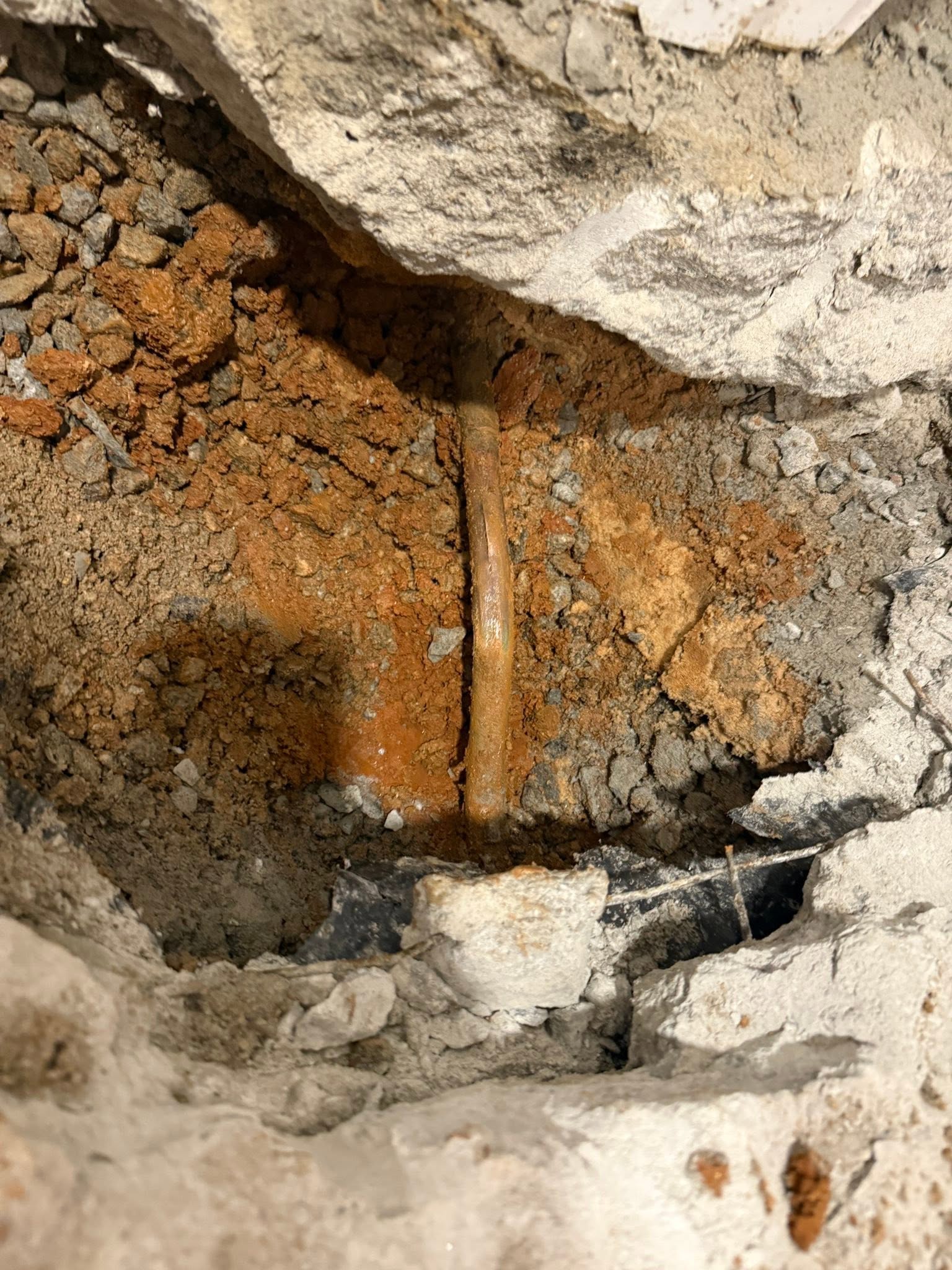 Exposed water pipe after excavation to repair a leak